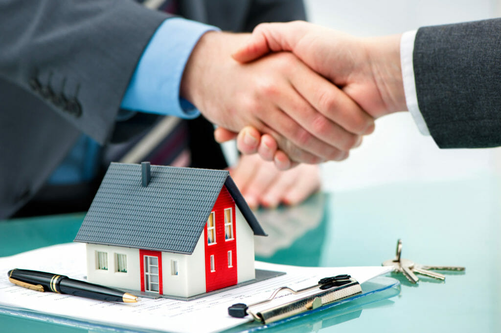 Property Management worker shaking hands with customer after contract signature